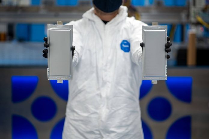 A Solid Power manufacturing engineer holds two 20Ah all solid-state battery cells